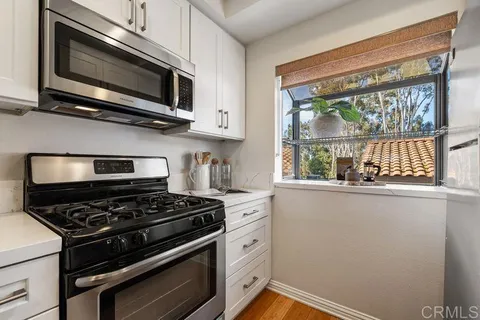 a kitchen with a stove and a microwave