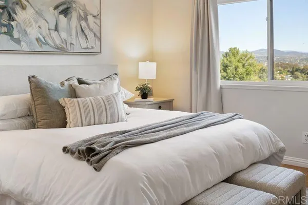 a bedroom with a bed and a window