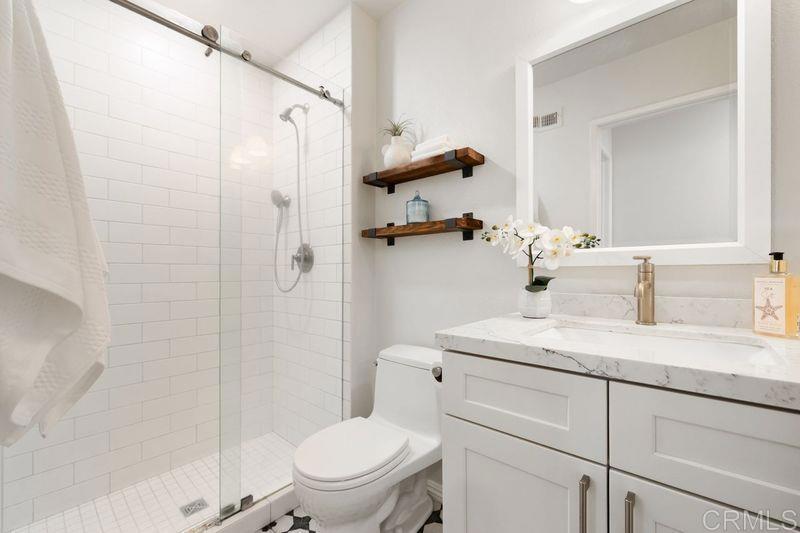 2118 Valleydale Lane Encinitas, CA 92024 - Photo 20 of 35 a bathroom with a granite countertop sink toilet and shower