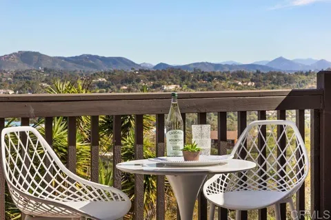 a view of a chairs and table in patio