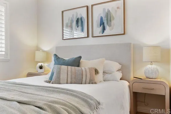 a bedroom with bed and wall painting