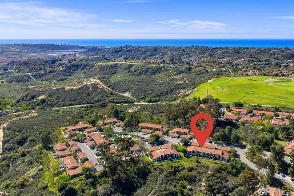 an aerial view of a houses with a yard