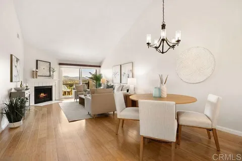 a view of a livingroom with furniture a fireplace and wooden floor