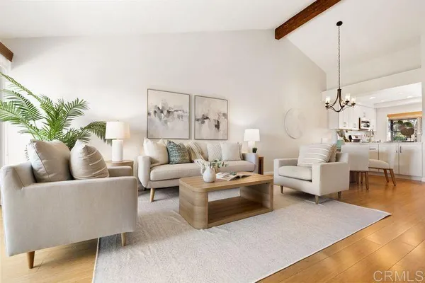 a living room with furniture and a chandelier