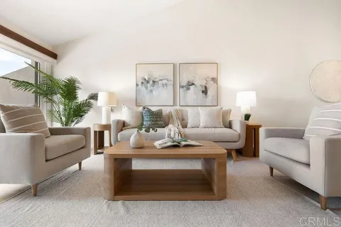 a living room with furniture and a potted plant
