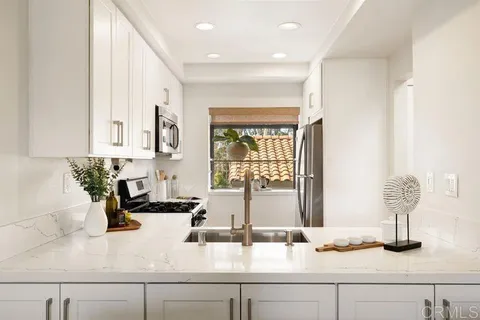 a kitchen with granite countertop a sink and a counter top space