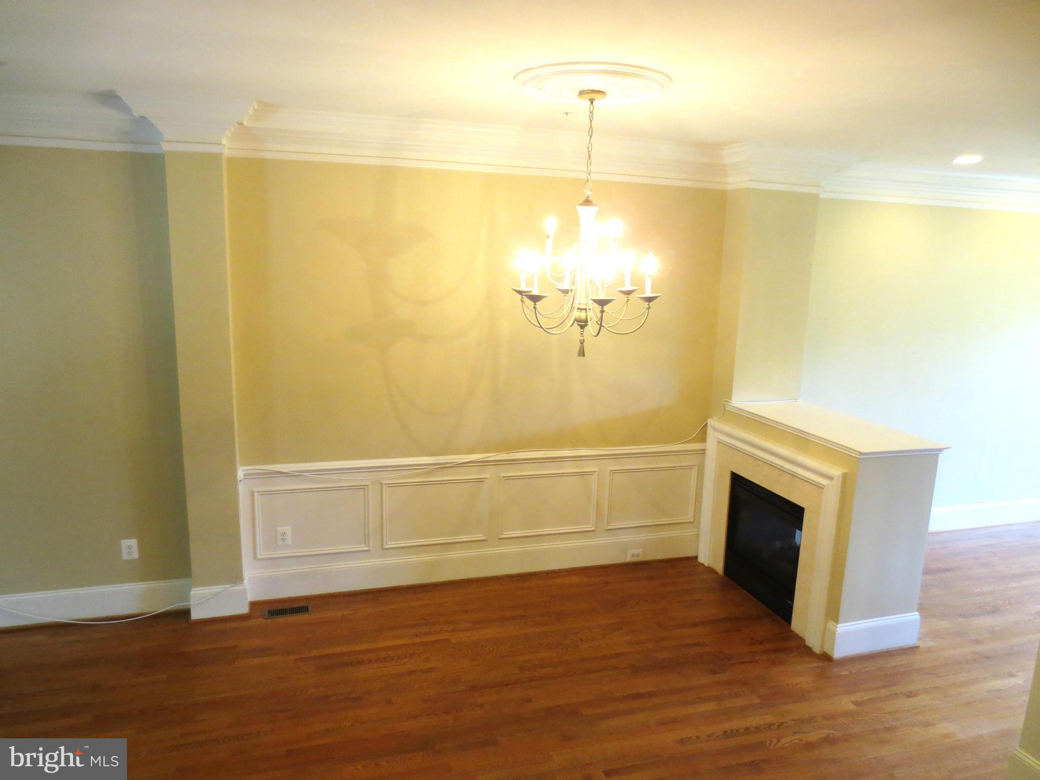 716 Carpenter Road Alexandria, VA 22314 - Photo 14 of 28 a view of empty room with wooden floor and fireplace