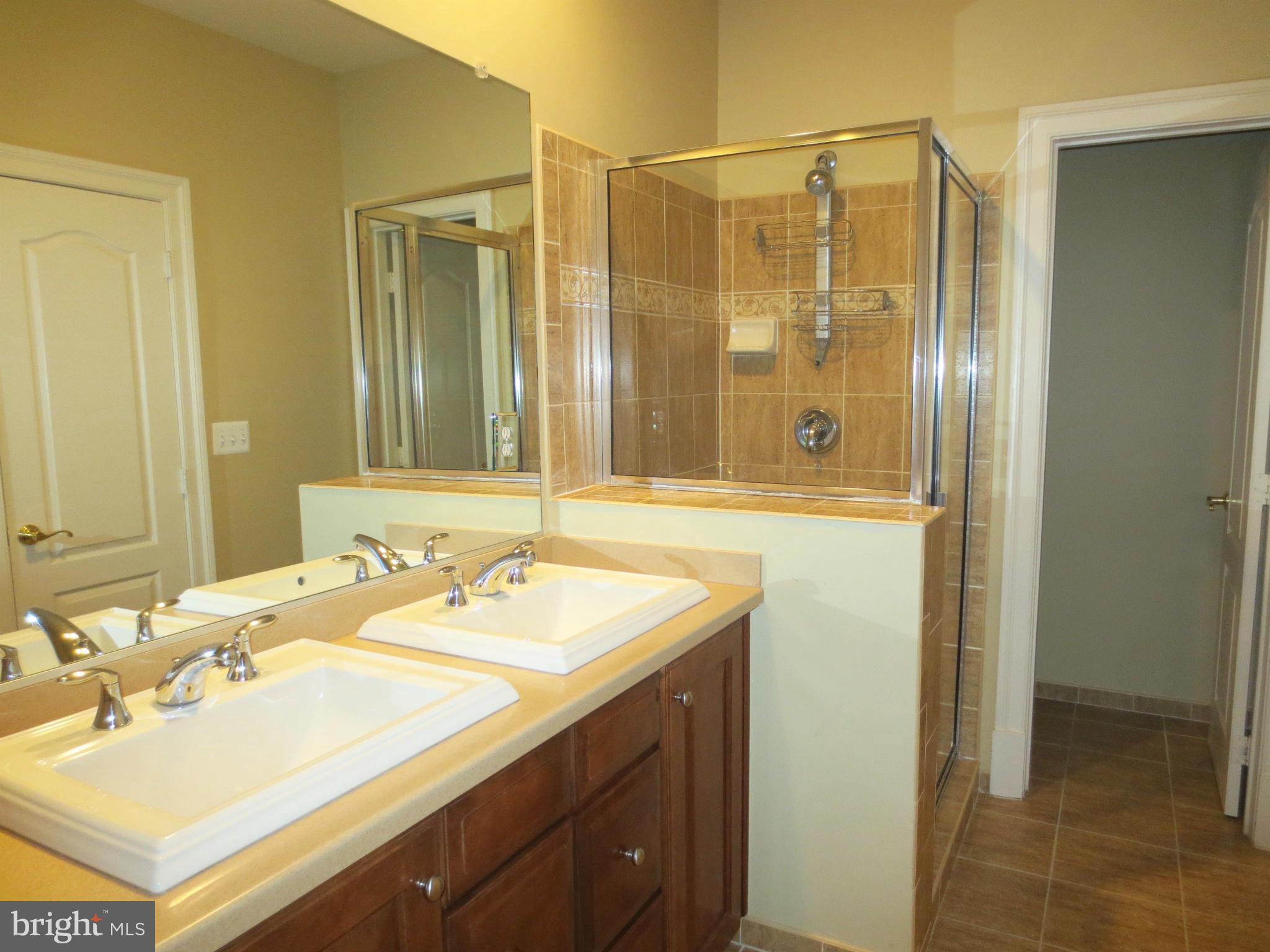716 Carpenter Road Alexandria, VA 22314 - Photo 17 of 28 a bathroom with a sink double vanity and a mirror