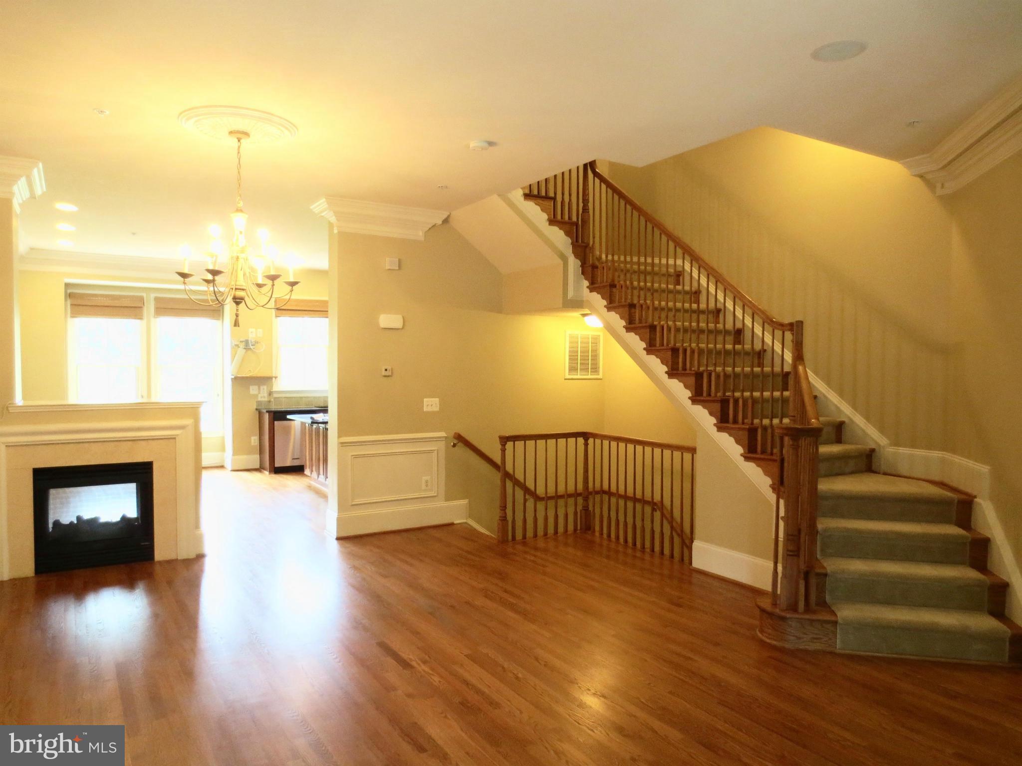716 Carpenter Road Alexandria, VA 22314 - Photo 6 of 28 a view of a livingroom with wooden floor and a fireplace