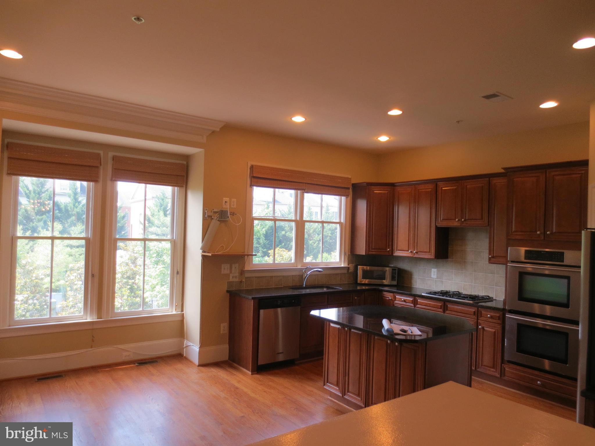 716 Carpenter Road Alexandria, VA 22314 - Photo 9 of 28 a kitchen with a sink a stove and cabinets