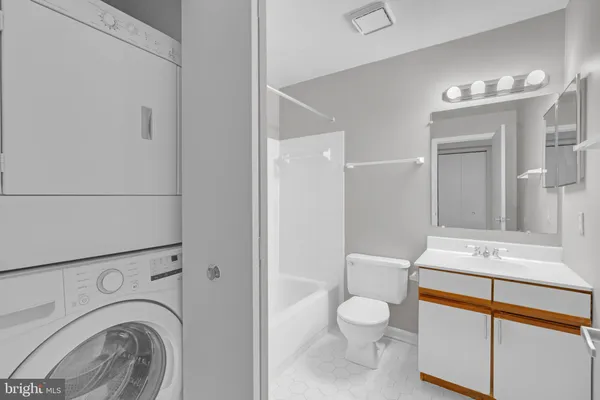 a bathroom with a sink vanity mirror and toilet