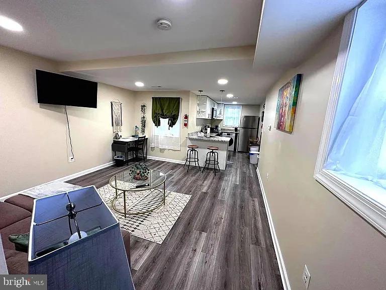 1721 McCulloh Street, Unit 3 Baltimore, MD 21217 - Photo 5 of 11 a living room with furniture and a flat screen tv