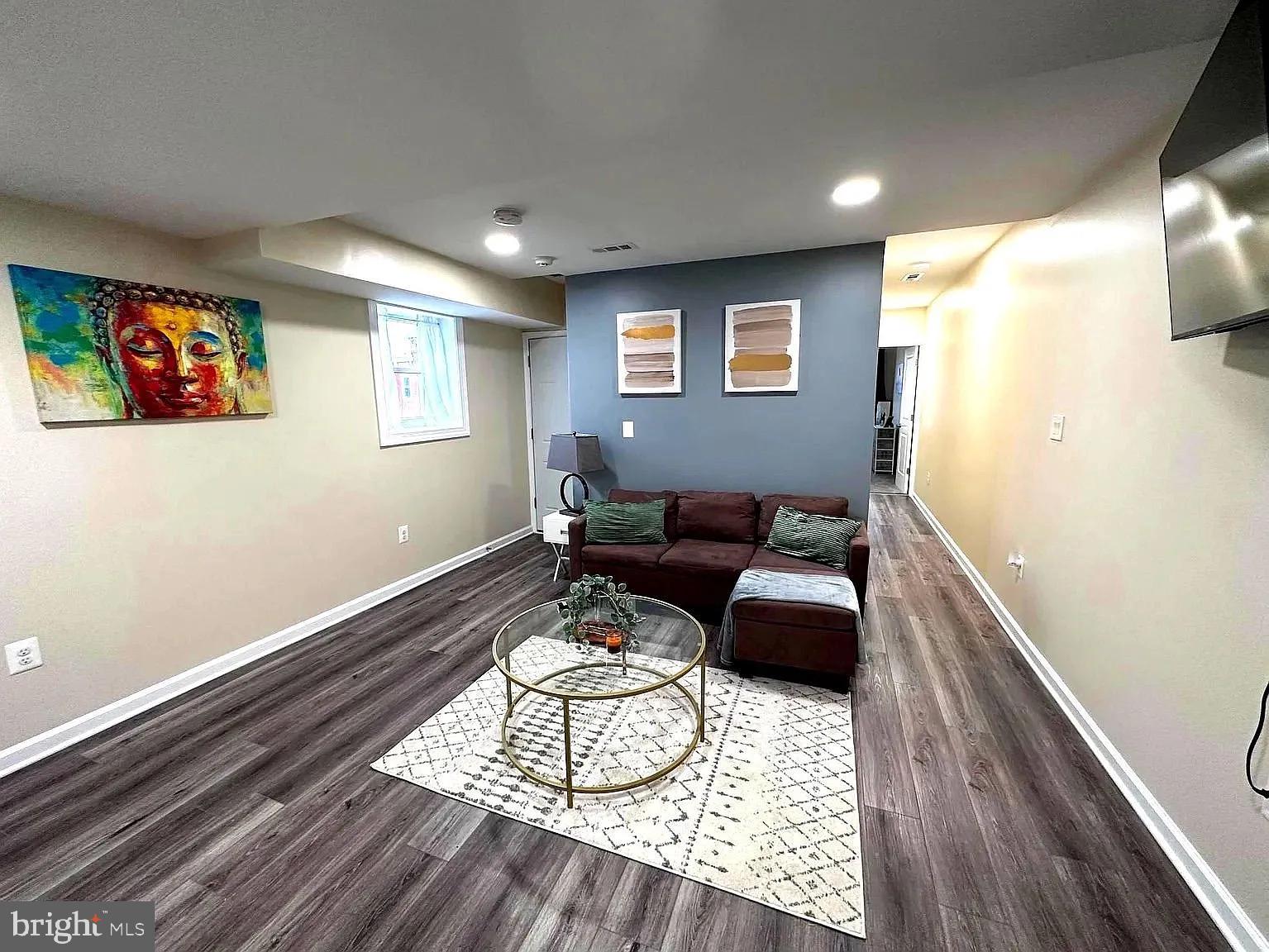 1721 McCulloh Street, Unit 3 Baltimore, MD 21217 - Photo 6 of 11 a living room with furniture and a wooden floor