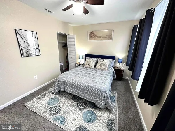 a bedroom with a bed and a rug
