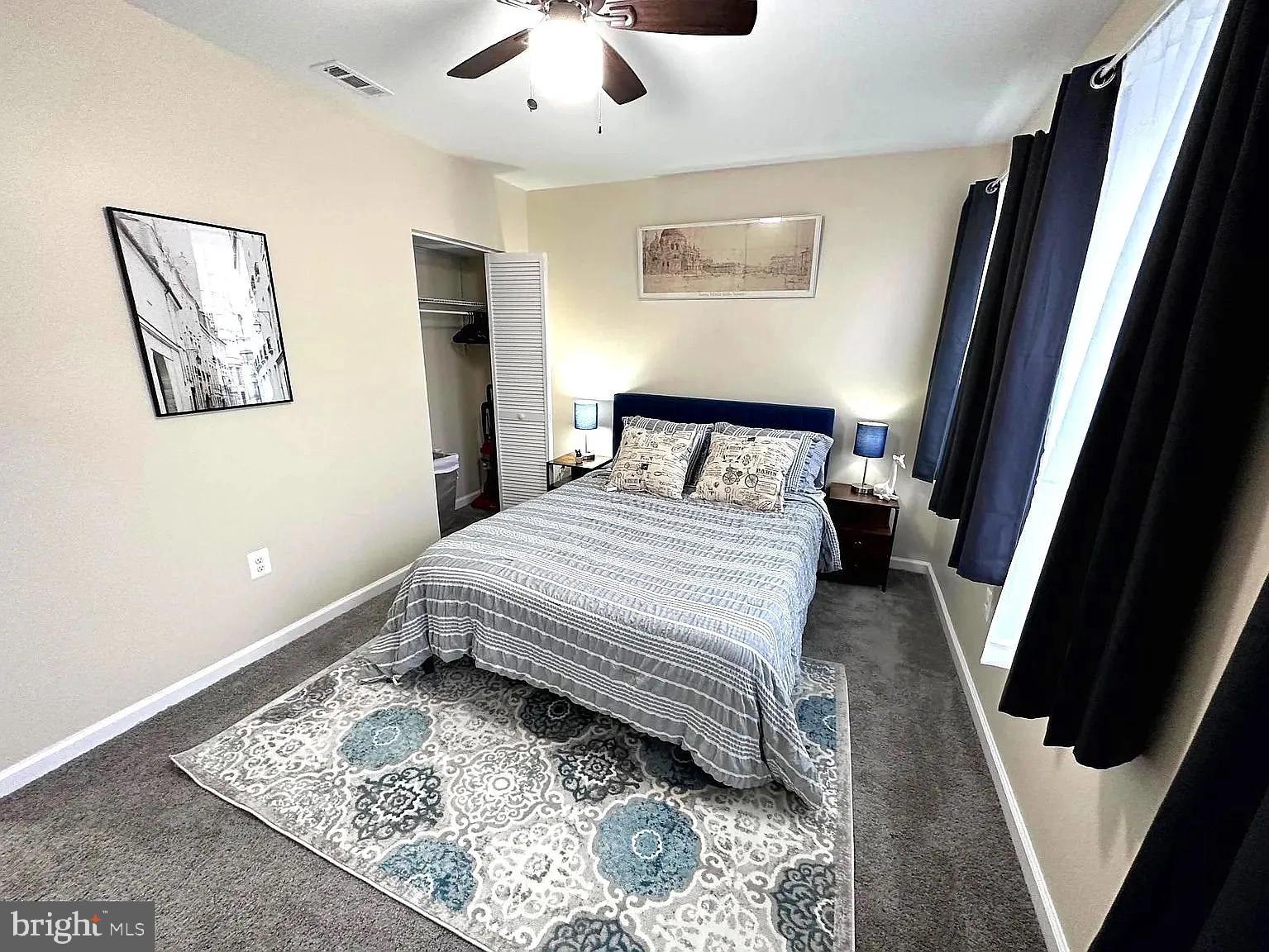 1721 McCulloh Street, Unit 3 Baltimore, MD 21217 - Photo 7 of 11 a bedroom with a bed and a rug