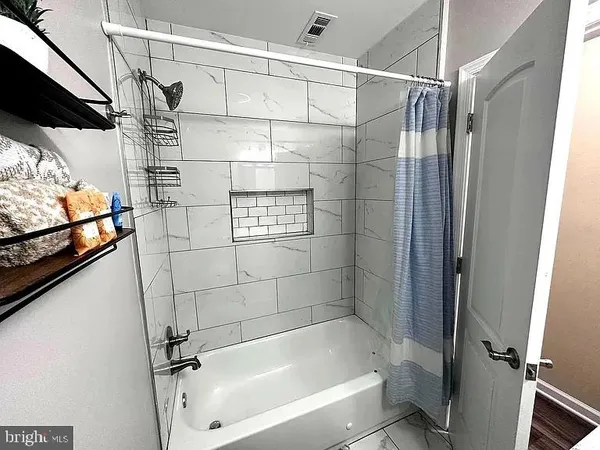 a bathroom with a bathtub and a shower