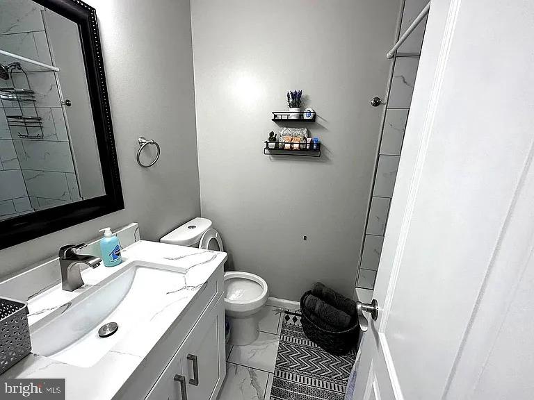 1721 McCulloh Street, Unit 3 Baltimore, MD 21217 - Photo 9 of 11 a bathroom with a sink toilet and mirror