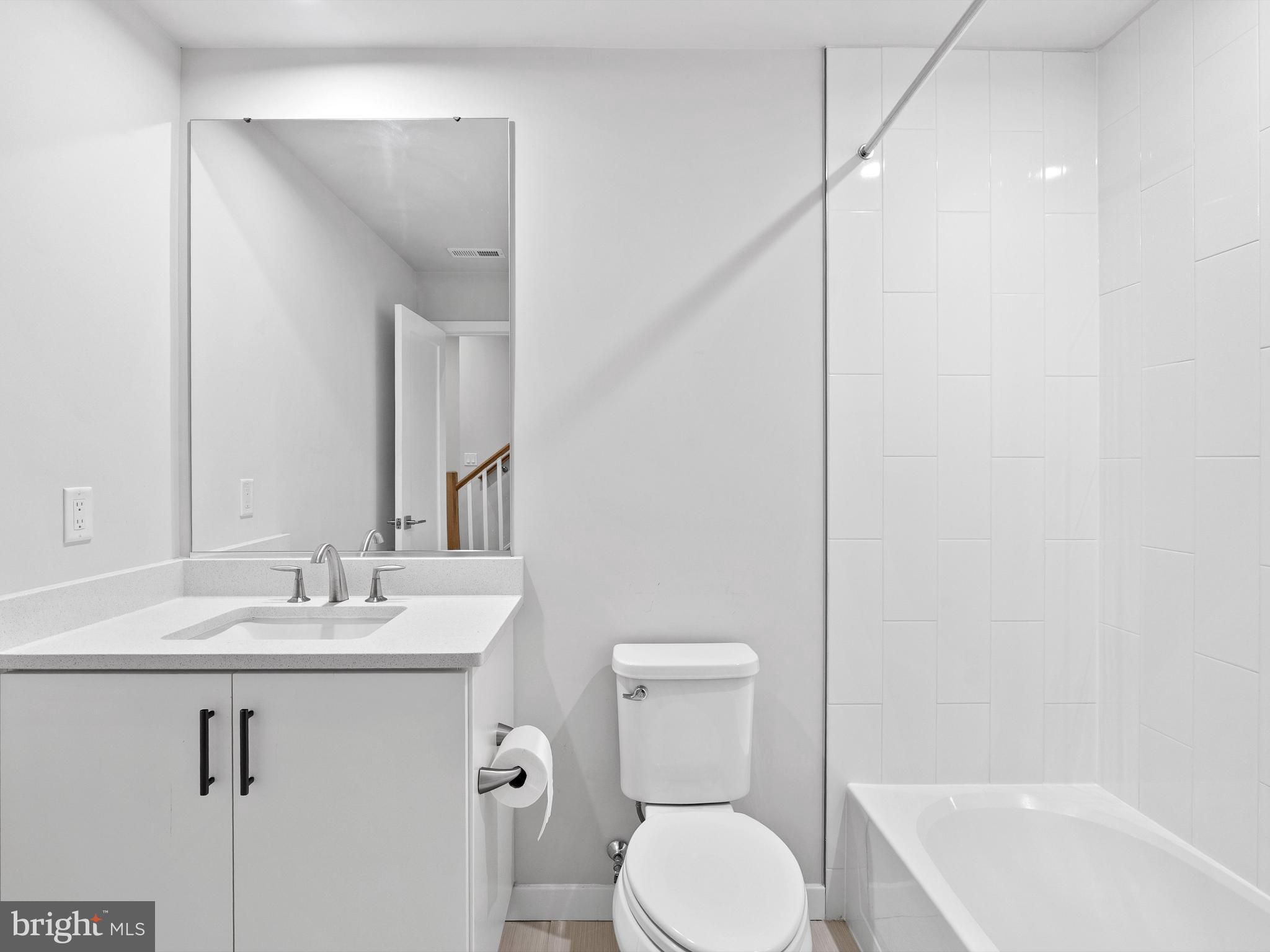 7465 Backett Wood Terrace, Unit 1215 McLean, VA 22102 - Photo 18 of 23 a bathroom with a sink a toilet and shower