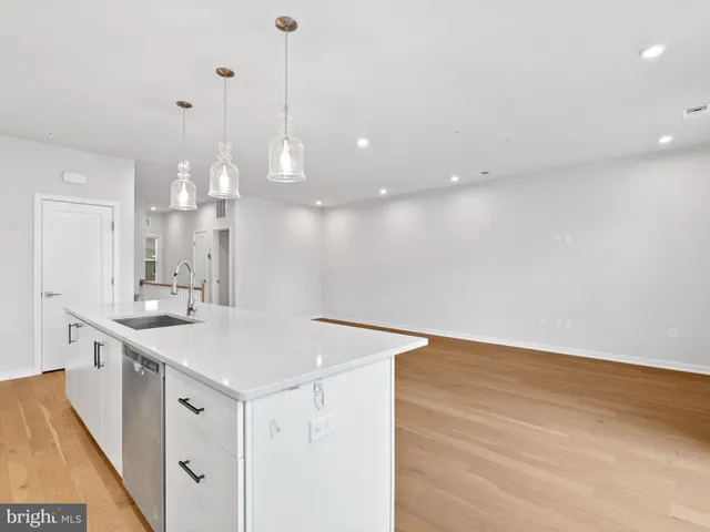 a view of a kitchen with a sink and chandelier
