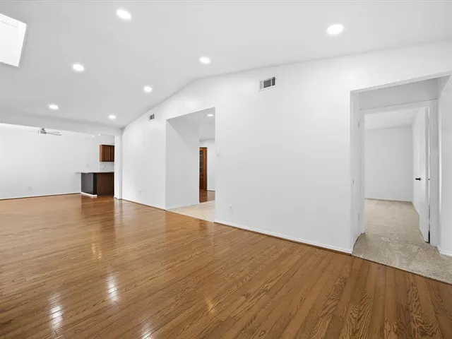 a view of kitchen with stainless steel appliances granite countertop a refrigerator and a sink