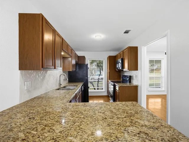 a kitchen with a refrigerator and a sink