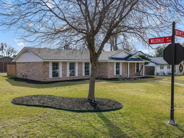 a front view of a house with a garden and swimming pool