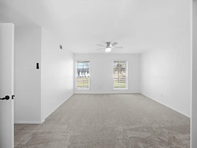 a view of a livingroom with a furniture and floor to ceiling window