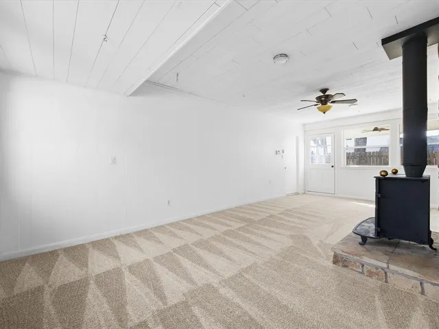 a view of empty room with a fireplace