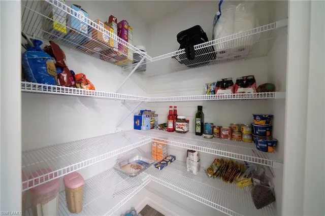 a kitchen with lots of storage and utility racks