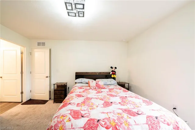 a bedroom with a bed and a cabinets