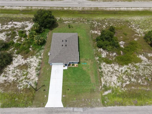 a aerial view of a house with a yard basket ball court and outdoor seating