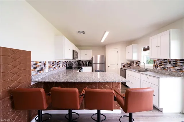 a view of kitchen and dining room with furniture