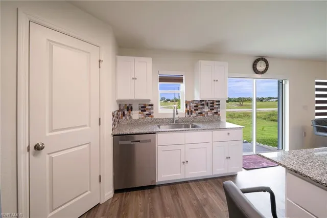 a kitchen with a sink stove and cabinets