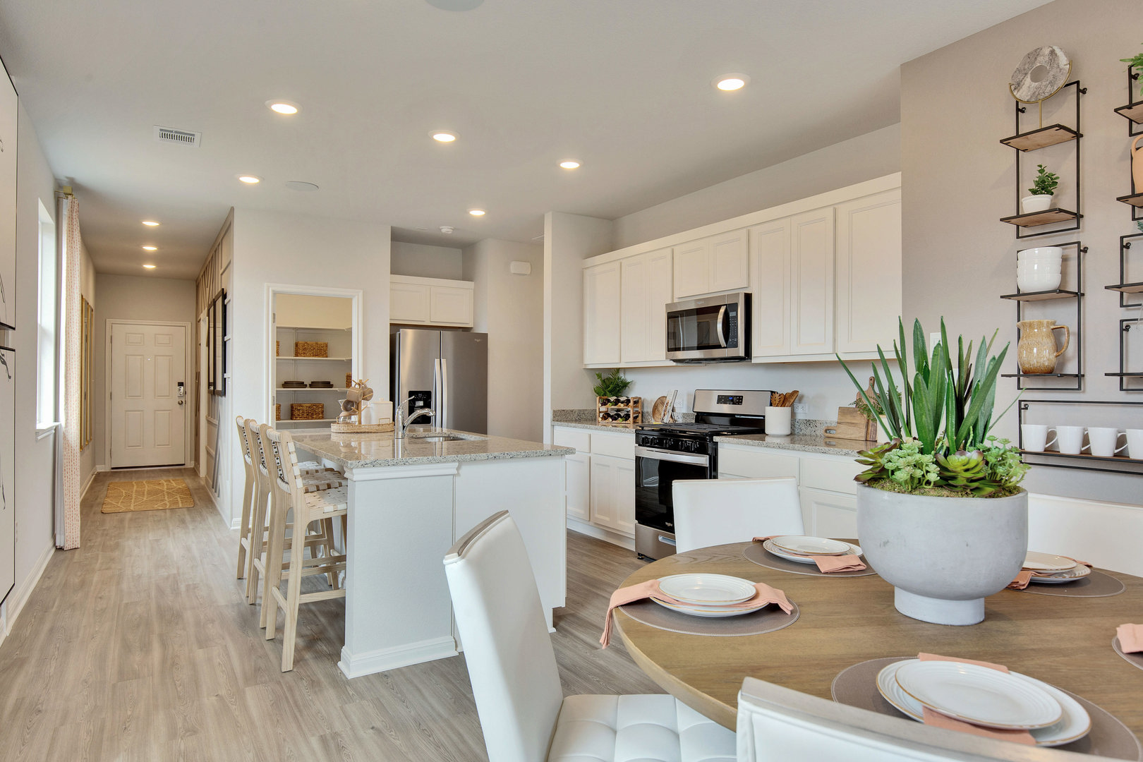 10605 Trifecta Way Buda, TX 78610 - Photo 5 of 11 A well-appointed kitchen features stainless steel appliances, granite countertops, and an inviting island for casual dining.