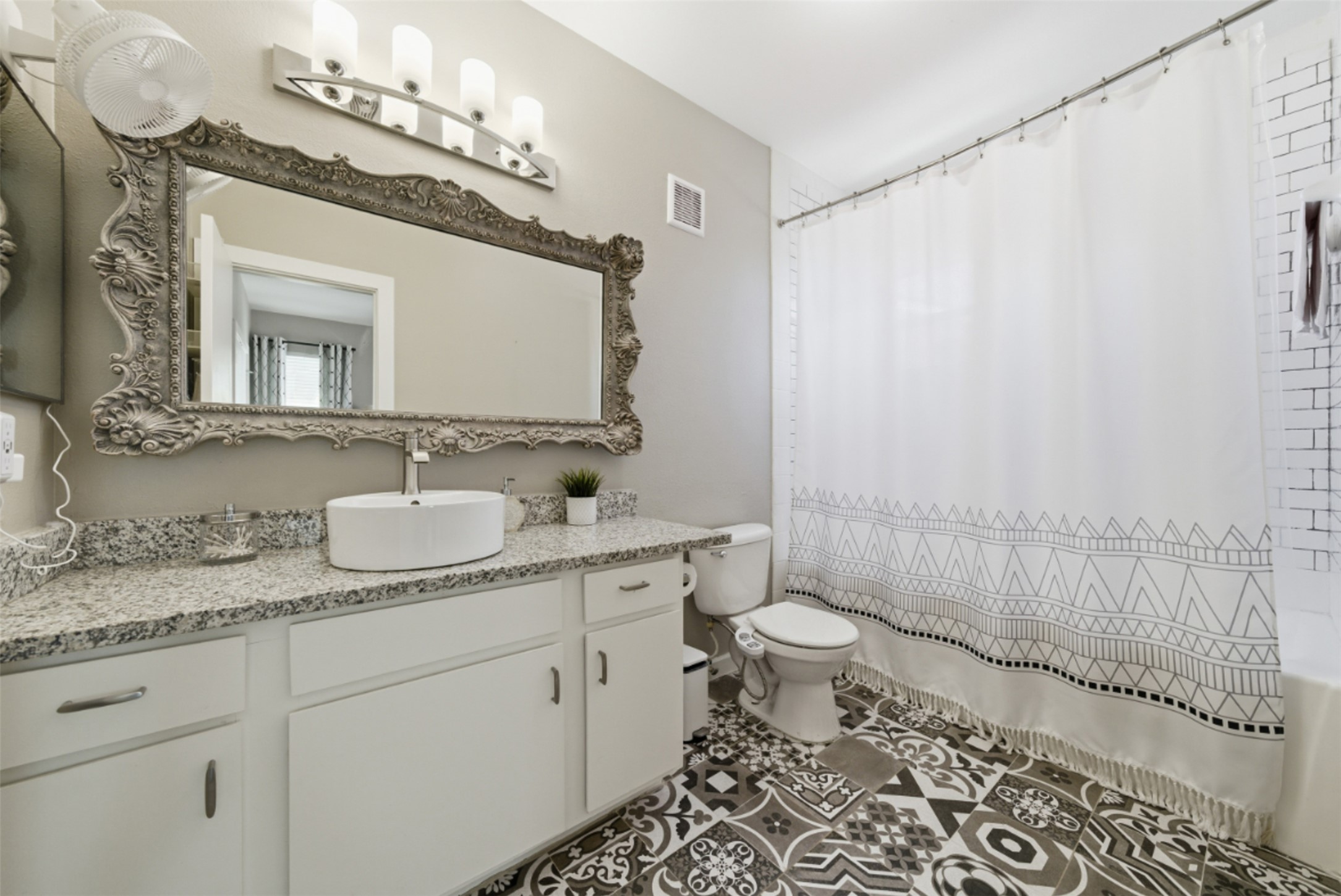 1201 Grove Boulevard, Unit 1304 Austin, TX 78741 - Photo 17 of 19 a bathroom with a granite countertop sink mirror vanity and toilet