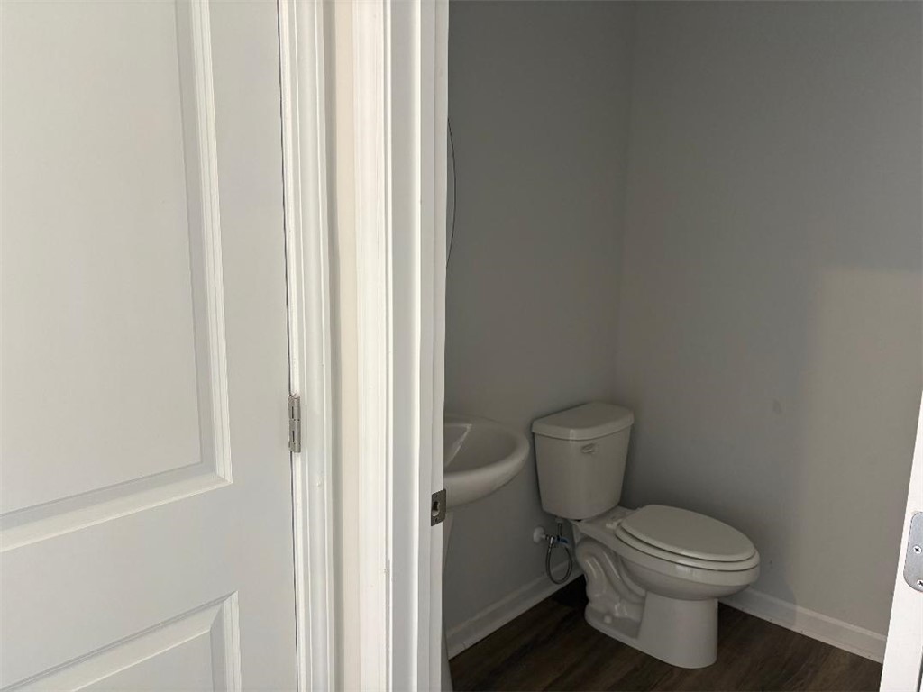 129 Cedar Shoals Easley, SC 29640 - Photo 9 of 31 A well-maintained bathroom with essential fixtures and wood-look flooring.