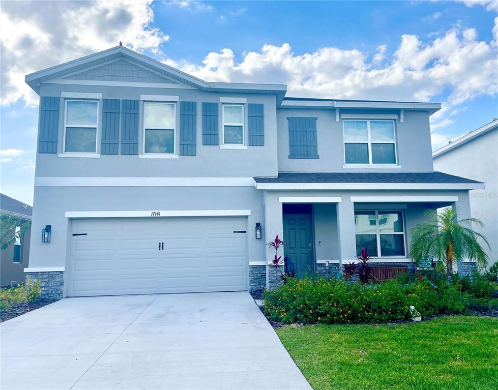 a front view of a house with a yard and garage
