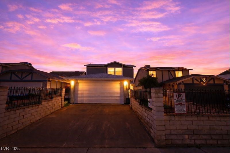 516 Inness Avenue Henderson, NV 89011 - Photo 2 of 42 View of front facade with concrete driveway and a garage