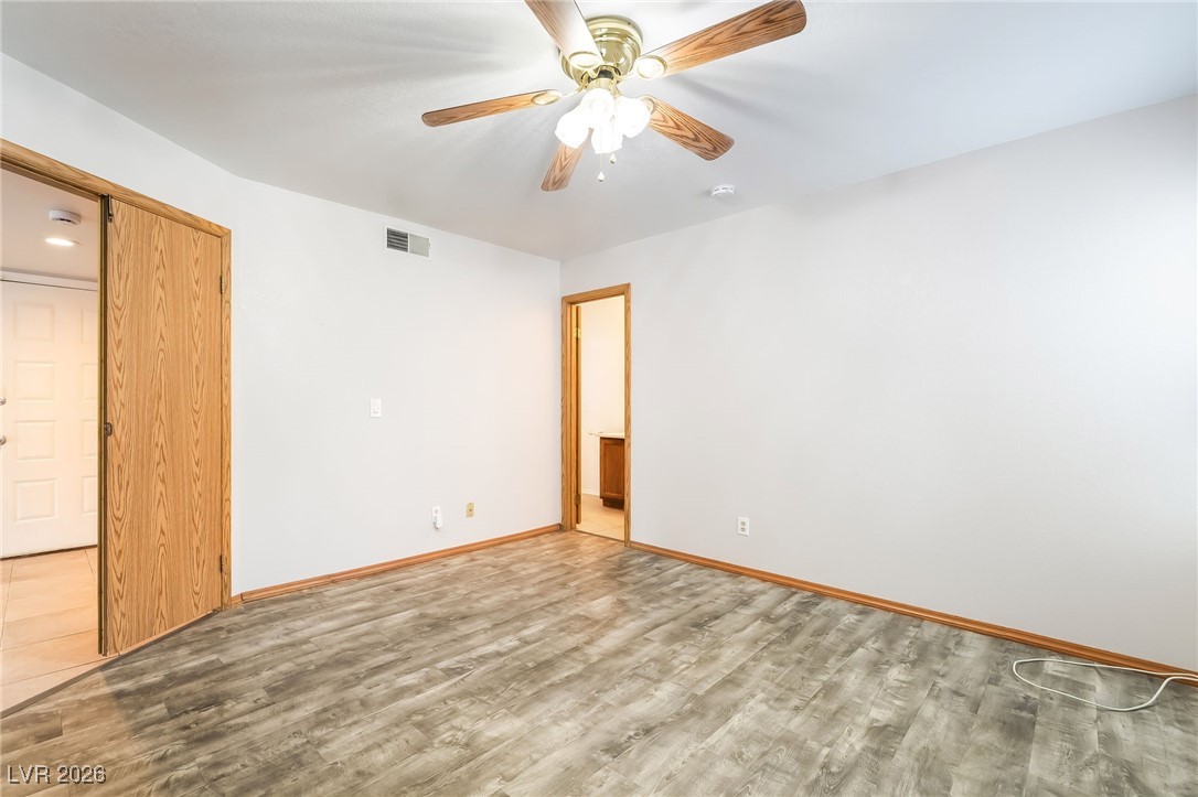 516 Inness Avenue Henderson, NV 89011 - Photo 23 of 42 Unfurnished bedroom featuring wood finished floors and a ceiling fan