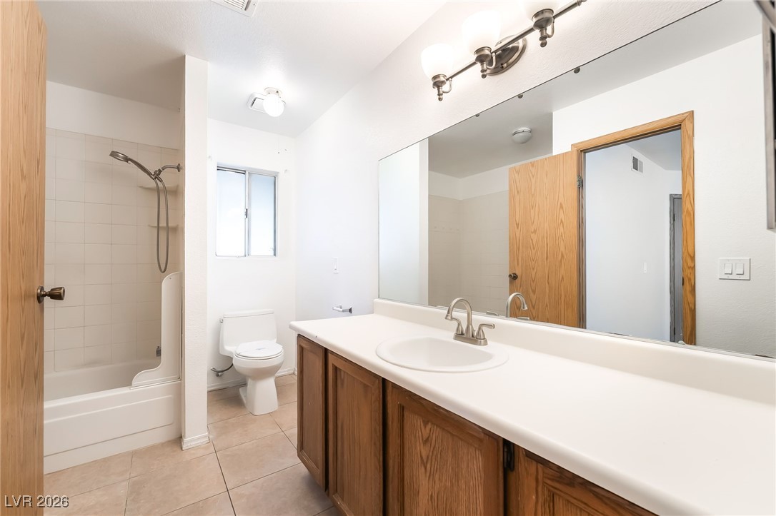 516 Inness Avenue Henderson, NV 89011 - Photo 25 of 42 Full bathroom with vanity, tub / shower combination, and light tile patterned floors