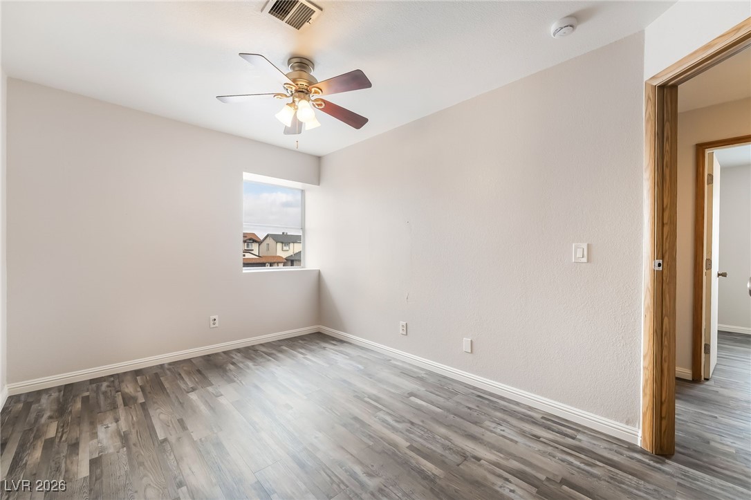 516 Inness Avenue Henderson, NV 89011 - Photo 33 of 42 Spare room with wood finished floors and a ceiling fan