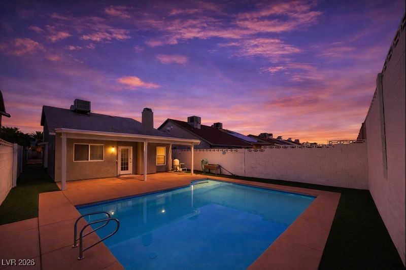 516 Inness Avenue Henderson, NV 89011 - Photo 37 of 42 Pool at dusk with a fenced backyard and a patio area