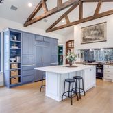 a kitchen with stainless steel appliances kitchen island a large window and cabinets