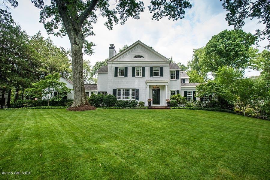 15 Owenoke Way Riverside, CT 06878 - Photo 1 of 22 a front view of a house with a yard and trees