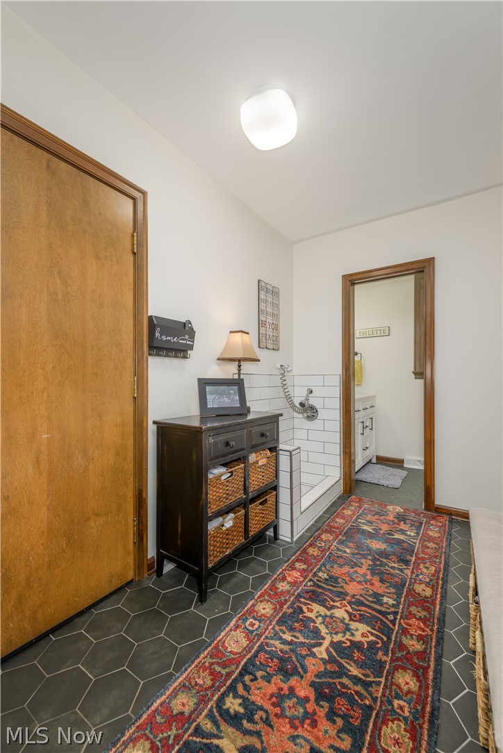 2447 Covington Road Akron, OH 44313 - Photo 22 of 46 Mudroom featuring a pet washing station, half-bath & updated tile flooring.