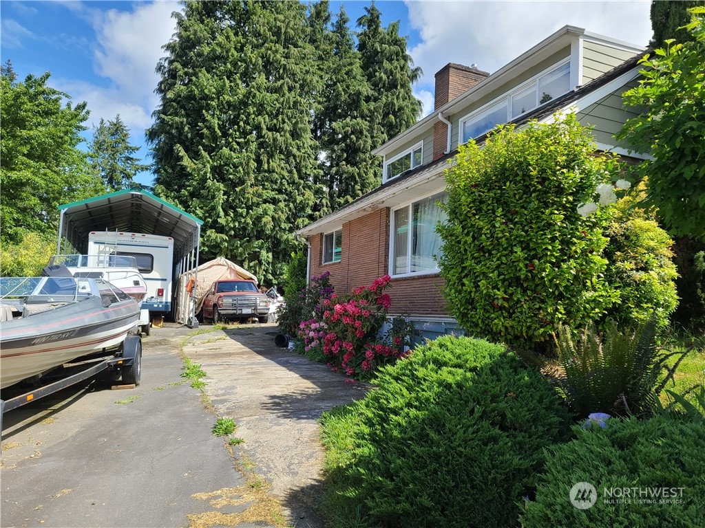 522 Northeast 127th Street Seattle, WA 98125 - Photo 3 of 28 a view of a backyard with couches and potted plants