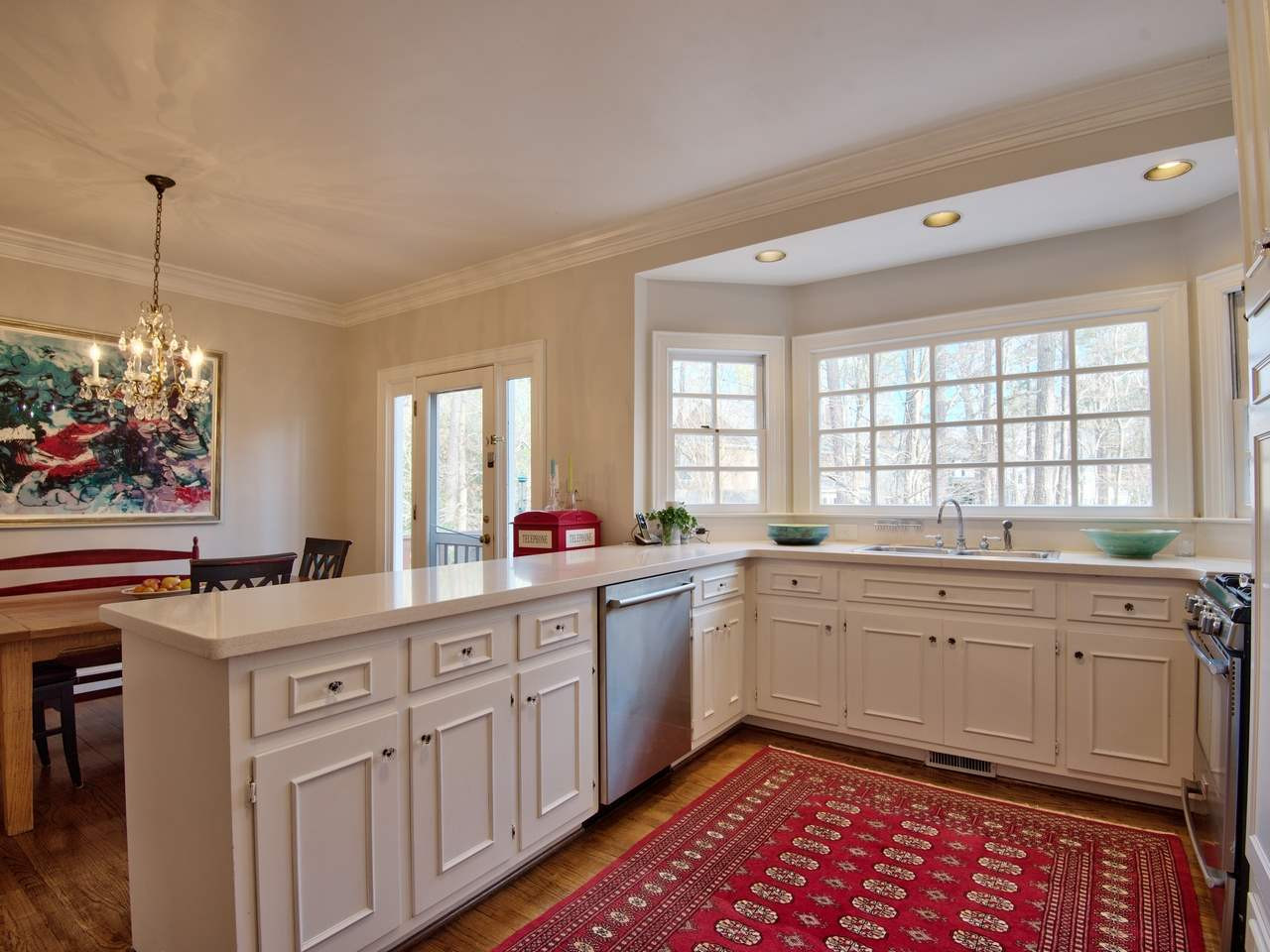 3809 Chippenham Road Durham, NC 27707 - Photo 7 of 23 Bright space with beautiful window, abundant cabinetry and storage. View of deck and screen porch help keep everyone close. Kitchen