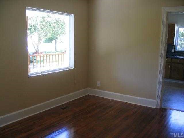1120 Clayton Road Durham, NC 27703 - Photo 5 of 8 a view of a room with wooden floor and a window