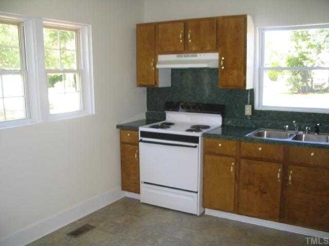 1120 Clayton Road Durham, NC 27703 - Photo 6 of 8 a kitchen with sink a window and cabinets