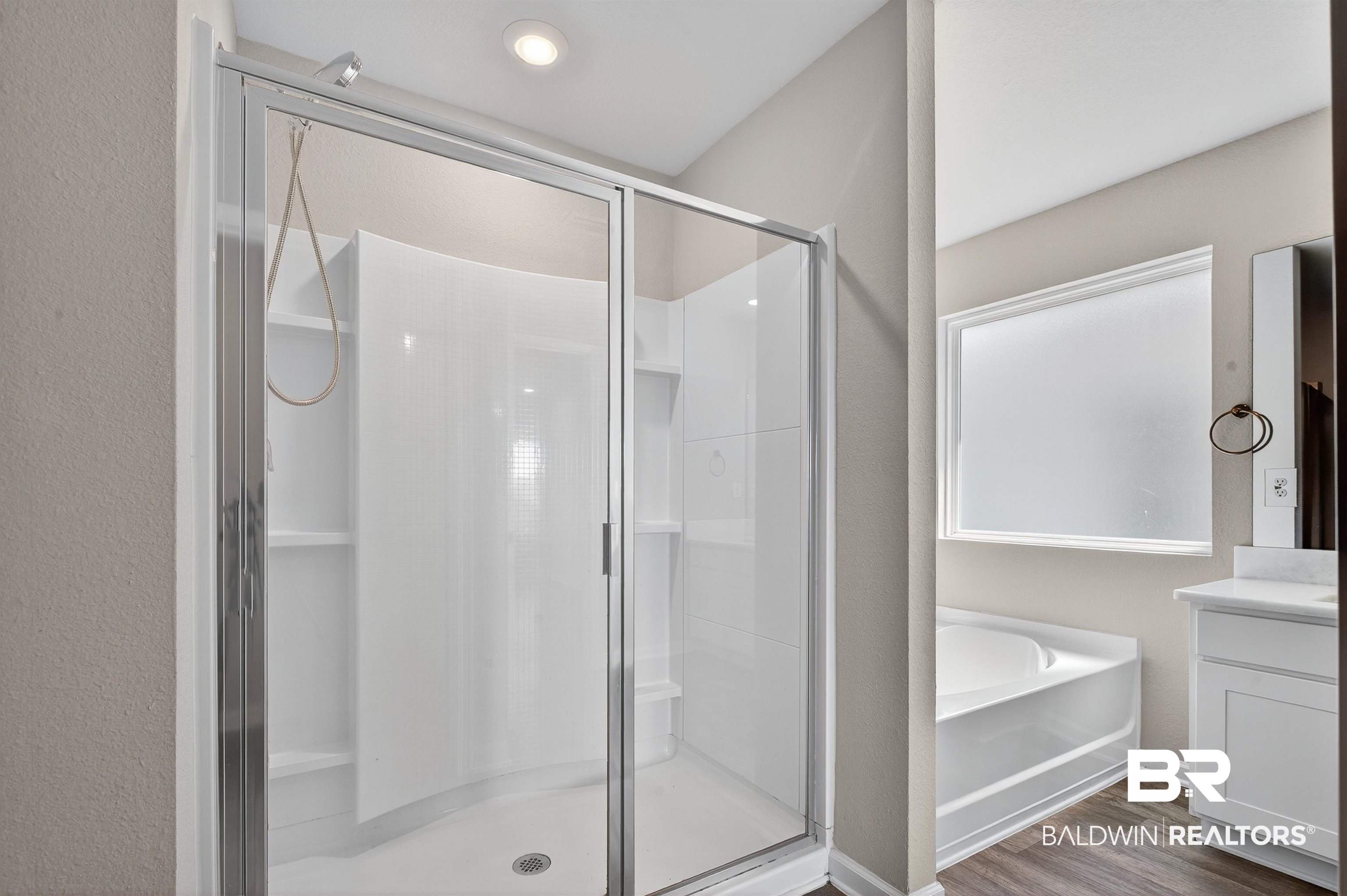 7429 Brompton Drive Foley, AL 36535 - Photo 29 of 50 Bathroom with a stall shower, vanity, a bath, dark wood finished floors, and a textured wall